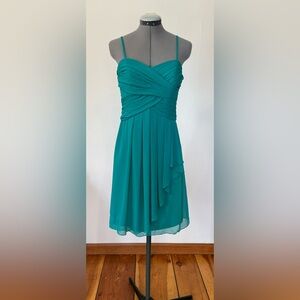Teal green chiffon dress with side ruffle detail and ruched crisscrossed bodice